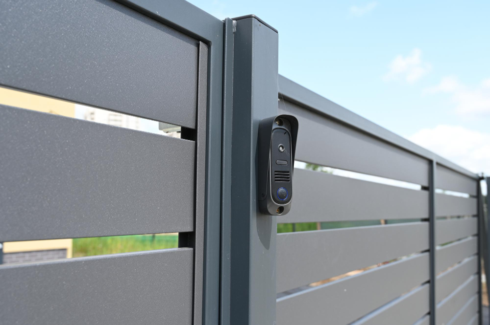 black-intercom-call-panel-mounted-panel-fence-anthracite-color-visible-wicketentrance-private-house